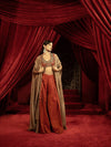 CRIMSON RED QUILTED BLOUSE WITH BOX PLEATED PANTS AND SEPIA BROWN CAPE