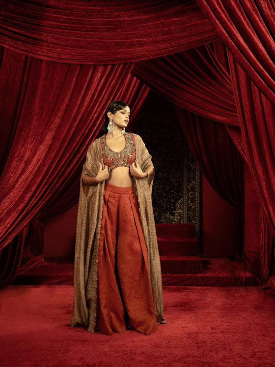 CRIMSON RED QUILTED BLOUSE WITH BOX PLEATED PANTS AND SEPIA BROWN CAPE