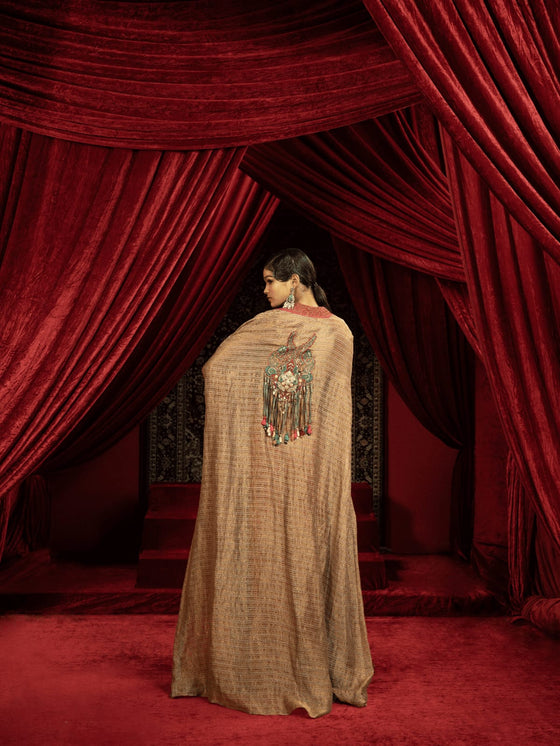 CRIMSON RED QUILTED BLOUSE WITH BOX PLEATED PANTS AND SEPIA BROWN CAPE