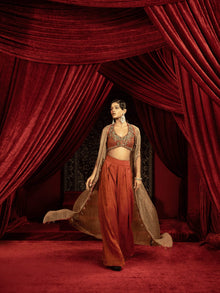  CRIMSON RED QUILTED BLOUSE WITH BOX PLEATED PANTS AND SEPIA BROWN CAPE